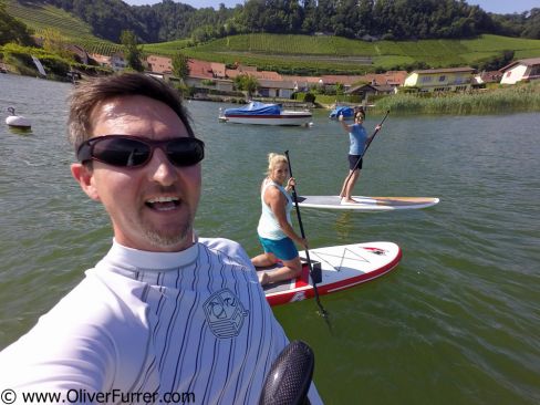 SUP paddeling along the shoreline on the lake Murten